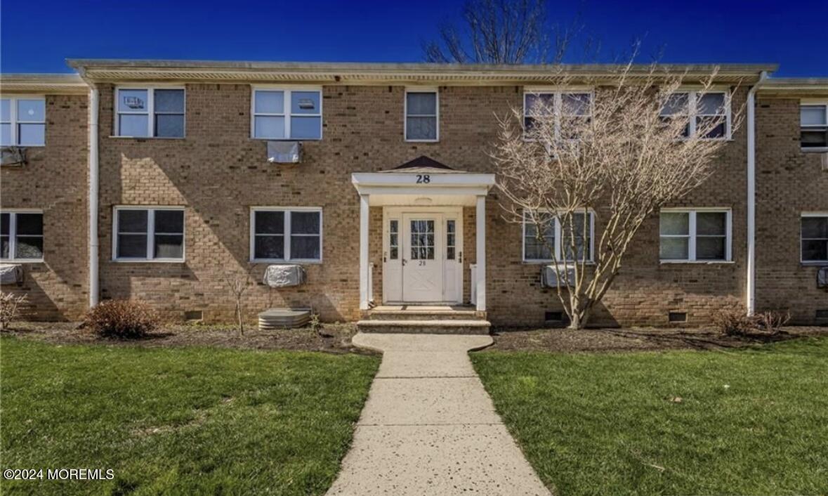 28 Manchester Court, Unit C Freehold, NJ 07728 - Photo 13 of 23 front view of a house with a yard