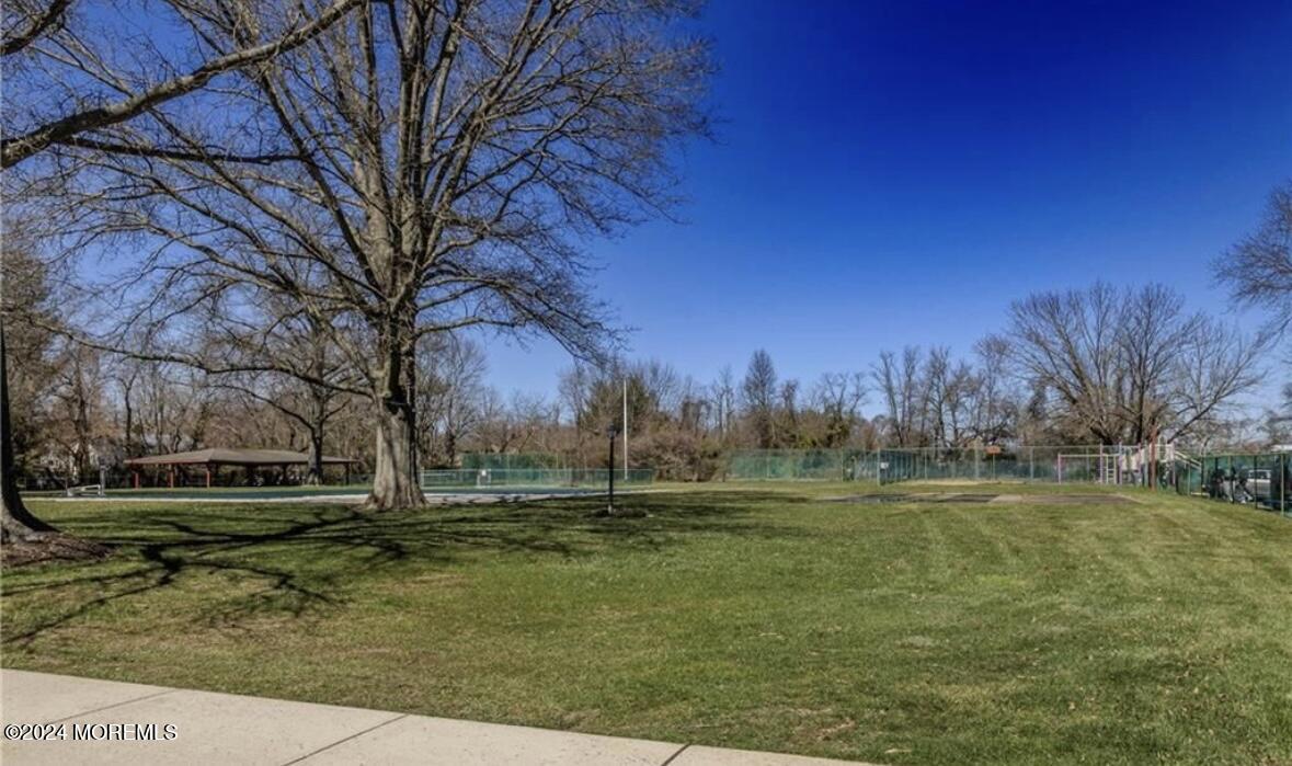 28 Manchester Court, Unit C Freehold, NJ 07728 - Photo 17 of 23 a backyard of apartments with large trees