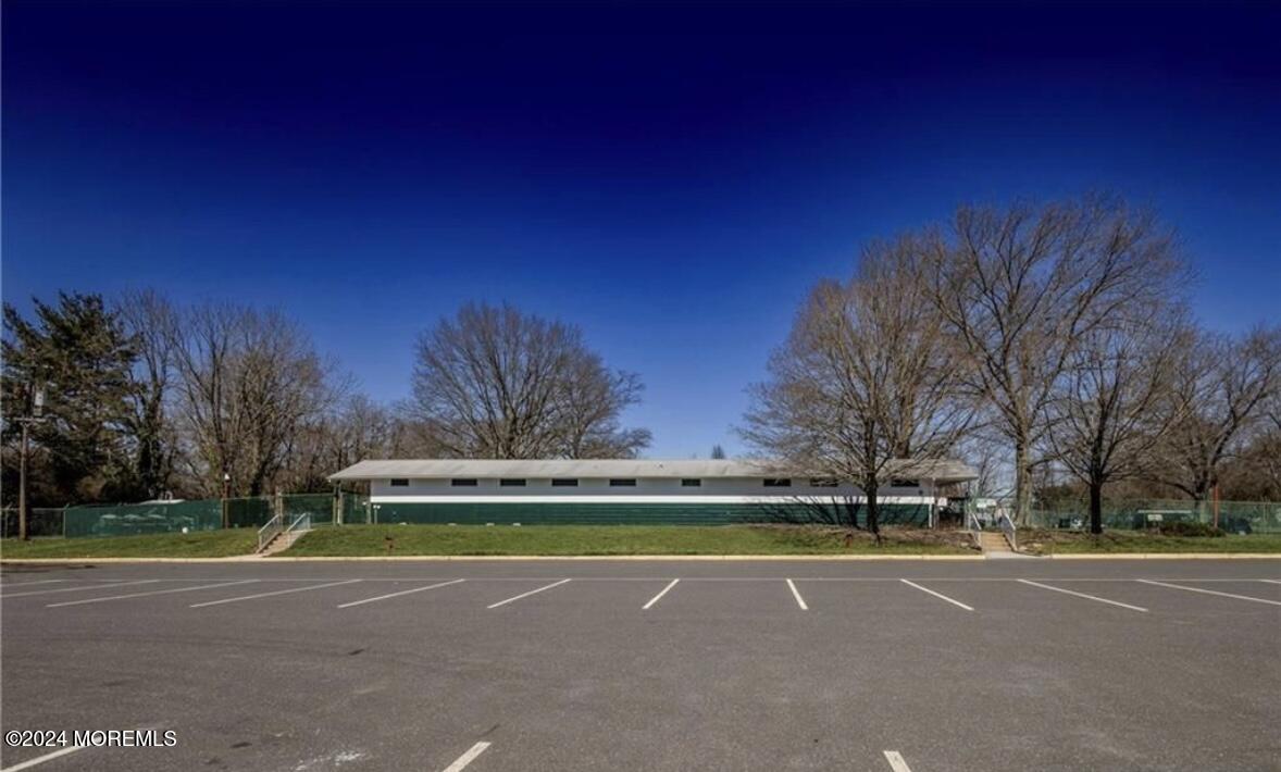 28 Manchester Court, Unit C Freehold, NJ 07728 - Photo 18 of 23 a view of a tennis ground with large trees