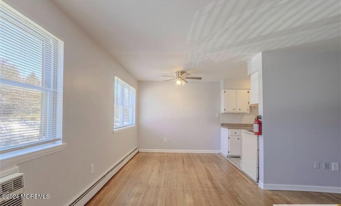 28 Manchester Court, Unit C Freehold, NJ 07728 - Photo 3 of 23 a view of empty room with wooden floor and fan