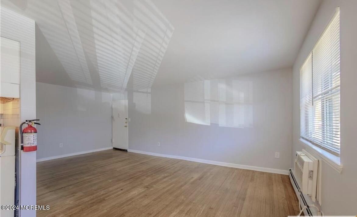 28 Manchester Court, Unit C Freehold, NJ 07728 - Photo 5 of 23 an empty room with wooden floor and windows