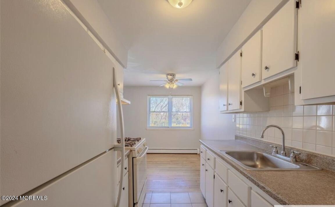 28 Manchester Court, Unit C Freehold, NJ 07728 - Photo 8 of 23 a kitchen that has a sink cabinets and a window