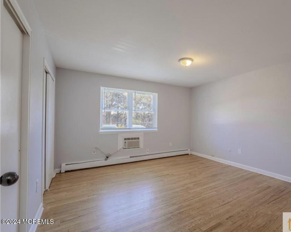 28 Manchester Court, Unit C Freehold, NJ 07728 - Photo 9 of 23 an empty room with wooden floor and windows
