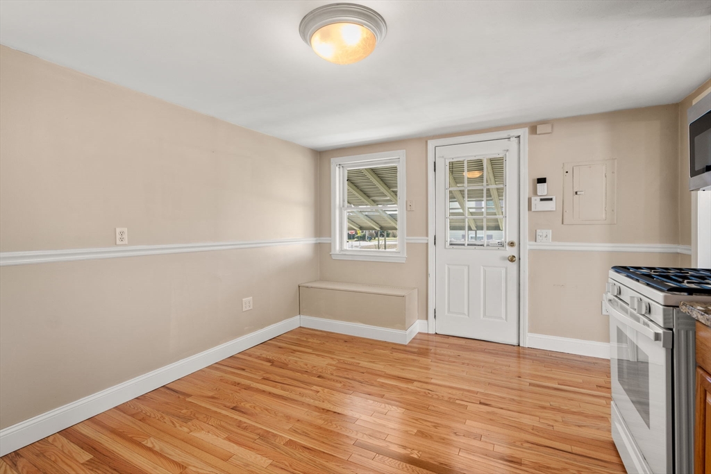 99 Proctor Road Braintree, MA 02184 - Photo 12 of 32 an empty room with wooden floor cabinet and windows