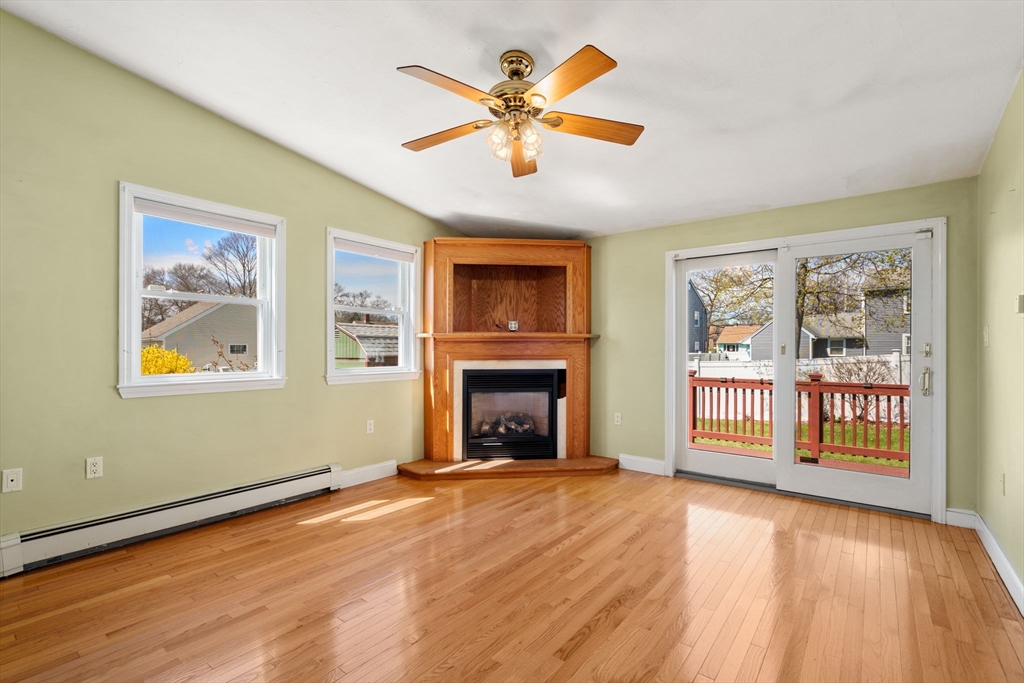 99 Proctor Road Braintree, MA 02184 - Photo 14 of 32 a view of an empty room with window and wooden floor