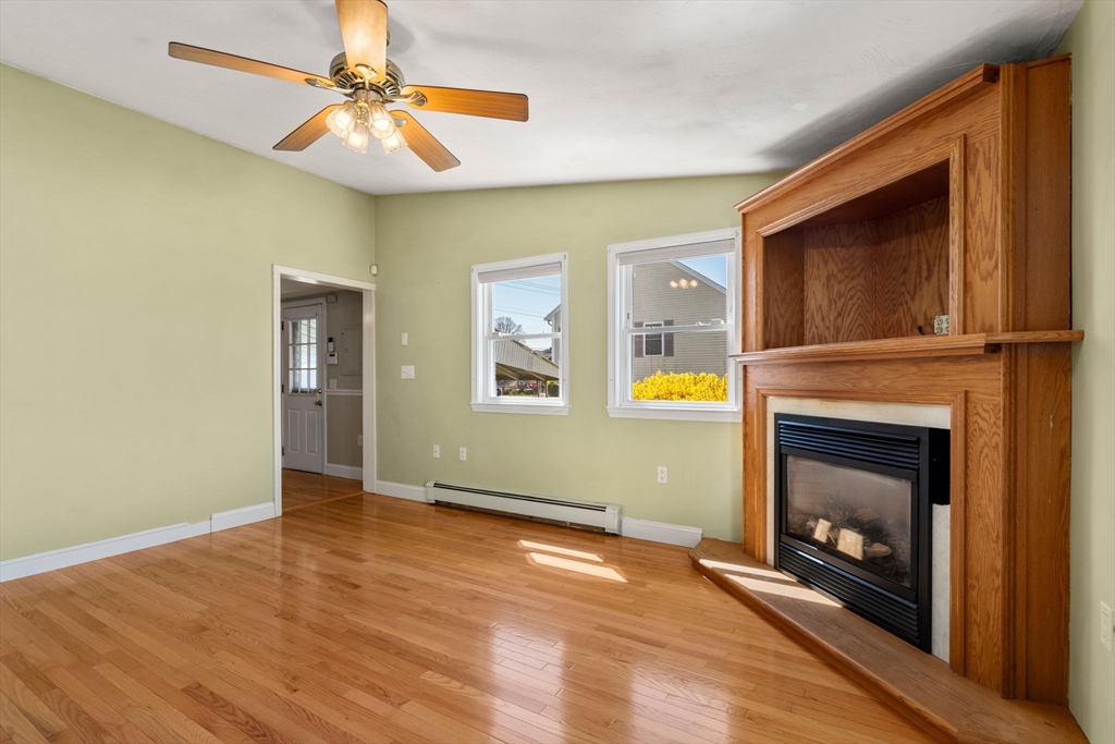99 Proctor Road Braintree, MA 02184 - Photo 16 of 32 a view of an empty room with window and fire place