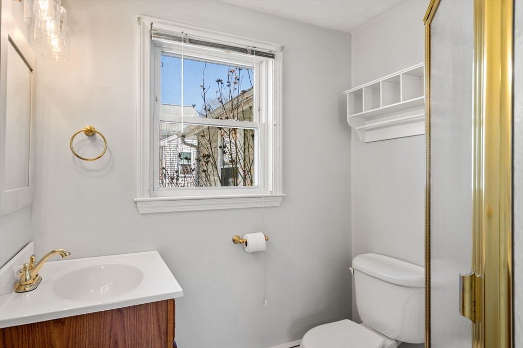 99 Proctor Road Braintree, MA 02184 - Photo 18 of 32 a bathroom with a toilet a sink and mirror