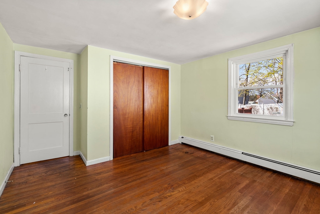 99 Proctor Road Braintree, MA 02184 - Photo 21 of 32 a view of an empty room with wooden floor and a window