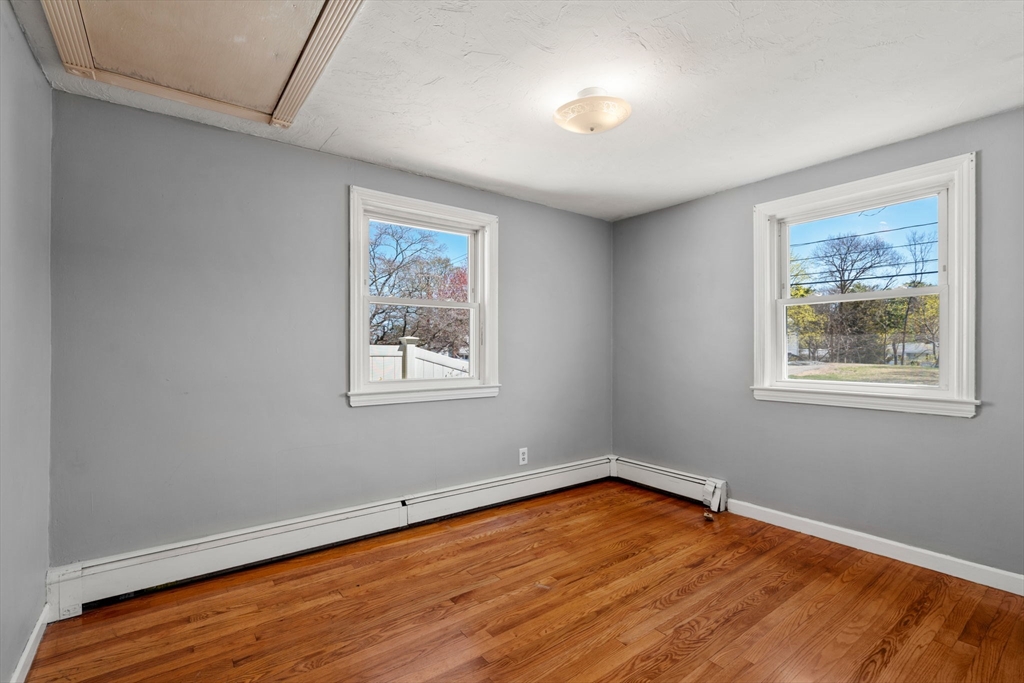 99 Proctor Road Braintree, MA 02184 - Photo 22 of 32 a view of an empty room with wooden floor and a window