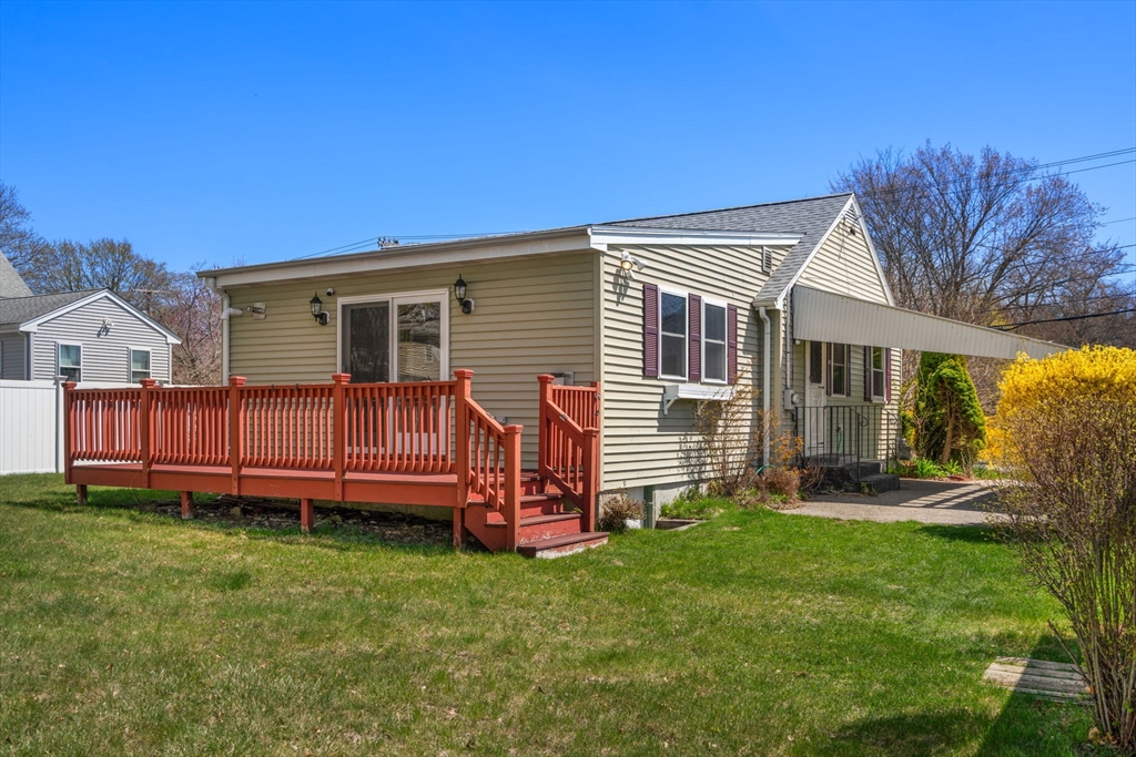 99 Proctor Road Braintree, MA 02184 - Photo 28 of 32 a backyard of a house with garden and deck