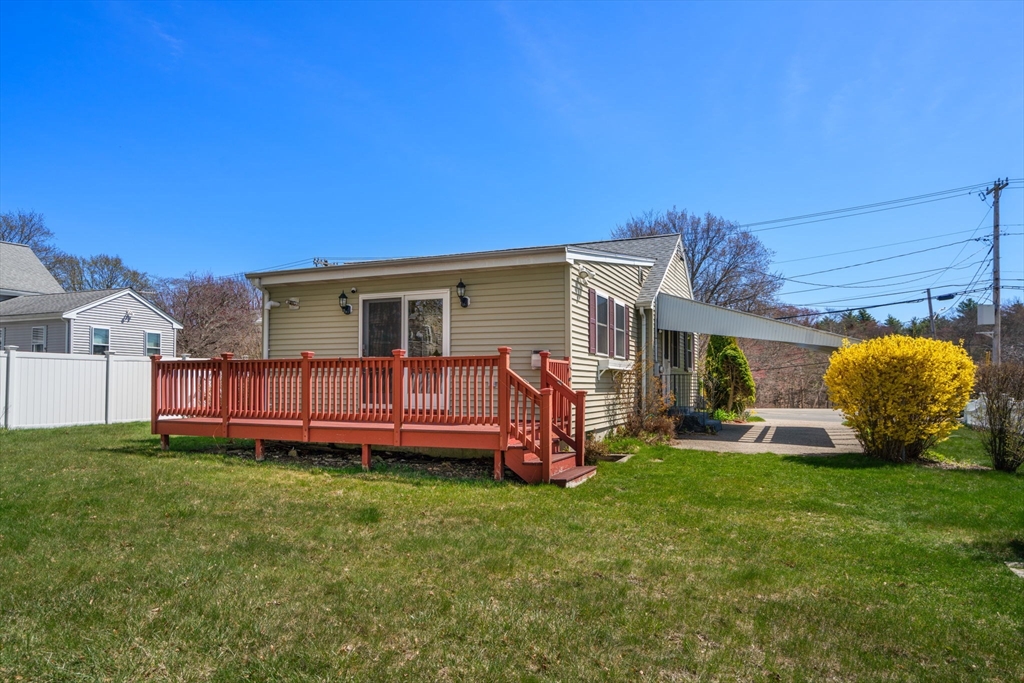 99 Proctor Road Braintree, MA 02184 - Photo 29 of 32 a view of a house with a yard and deck