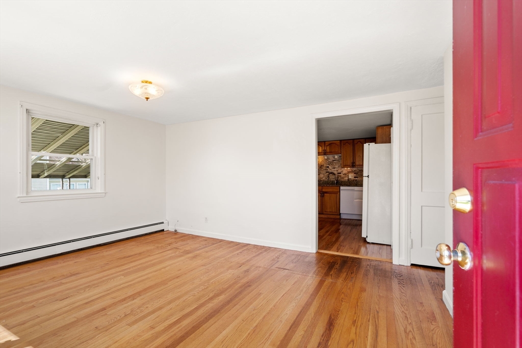 99 Proctor Road Braintree, MA 02184 - Photo 5 of 32 an empty room with wooden floor and windows