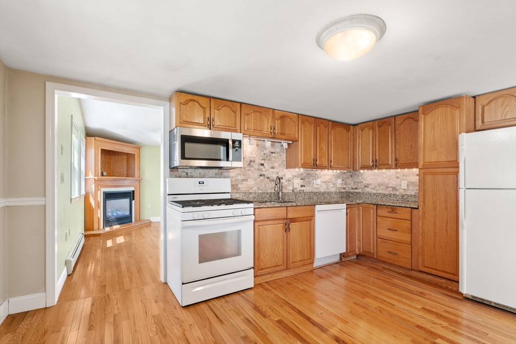 99 Proctor Road Braintree, MA 02184 - Photo 10 of 32 a kitchen with stainless steel appliances granite countertop a stove and a refrigerator