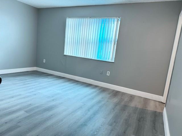 3110 North Pine Island Road, Unit 101 Sunrise, FL 33351 - Photo 11 of 14 an empty room with wooden floor and windows