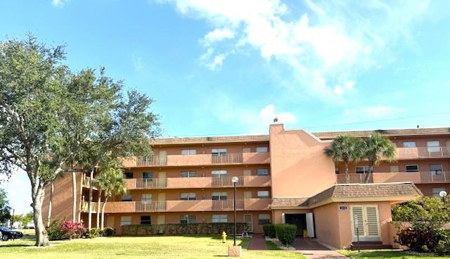 3110 North Pine Island Road, Unit 101 Sunrise, FL 33351 - Photo 14 of 14 a front view of a building with garden