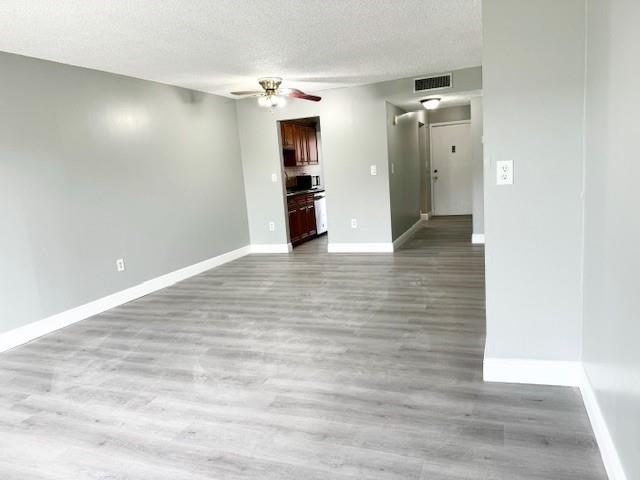 3110 North Pine Island Road, Unit 101 Sunrise, FL 33351 - Photo 5 of 14 a view of a hallway with wooden floor and a large mirror