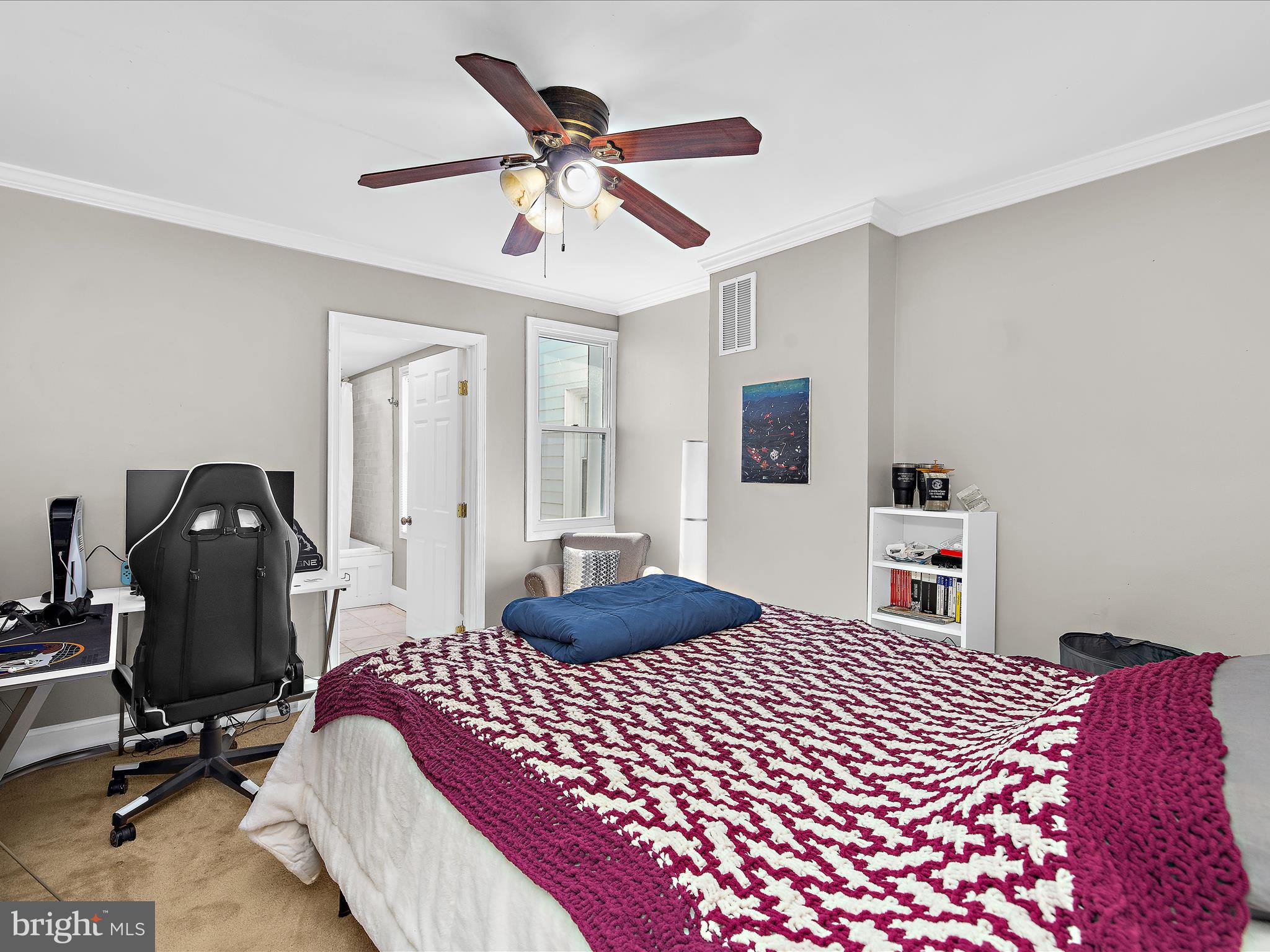 1313 Patapsco Street Baltimore, MD 21230 - Photo 14 of 30 a bedroom with a bed and a chandelier