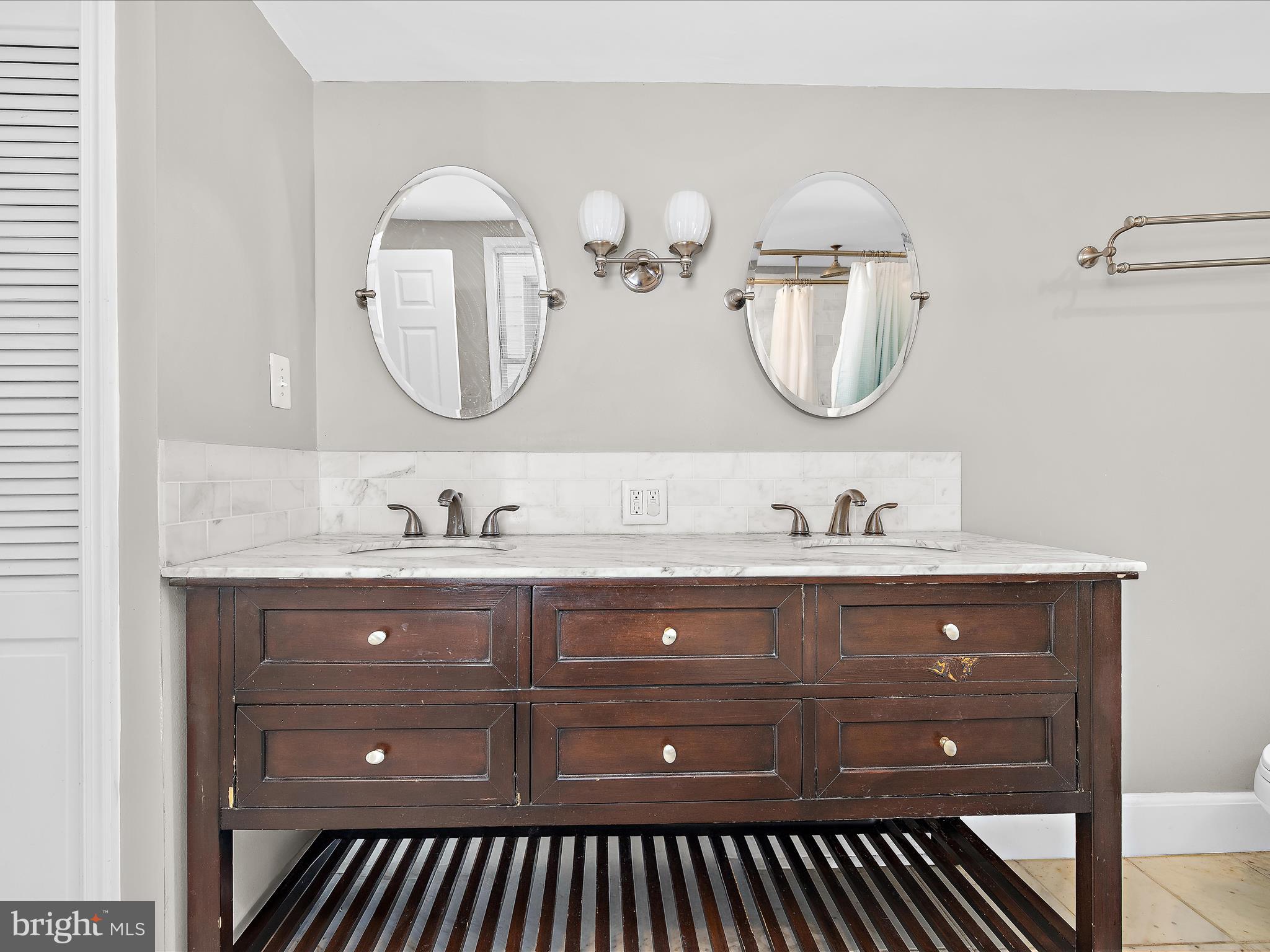 1313 Patapsco Street Baltimore, MD 21230 - Photo 18 of 30 a bathroom with a double vanity sink and a mirror