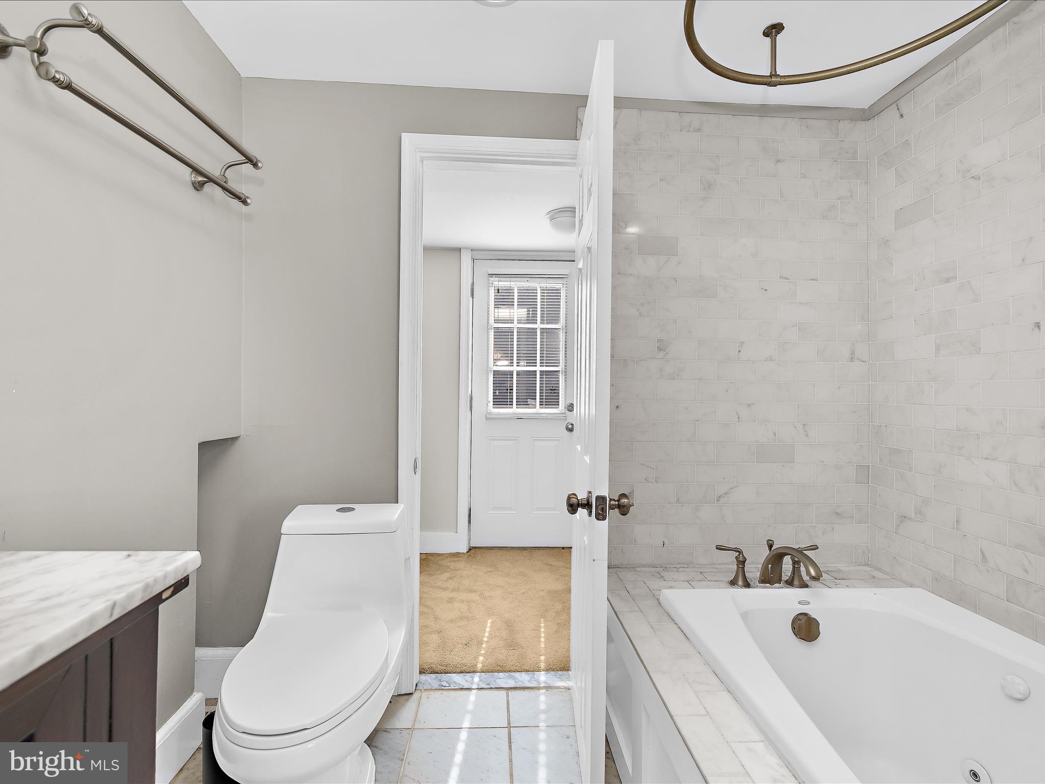 1313 Patapsco Street Baltimore, MD 21230 - Photo 19 of 30 a bathroom with a sink a toilet and shower