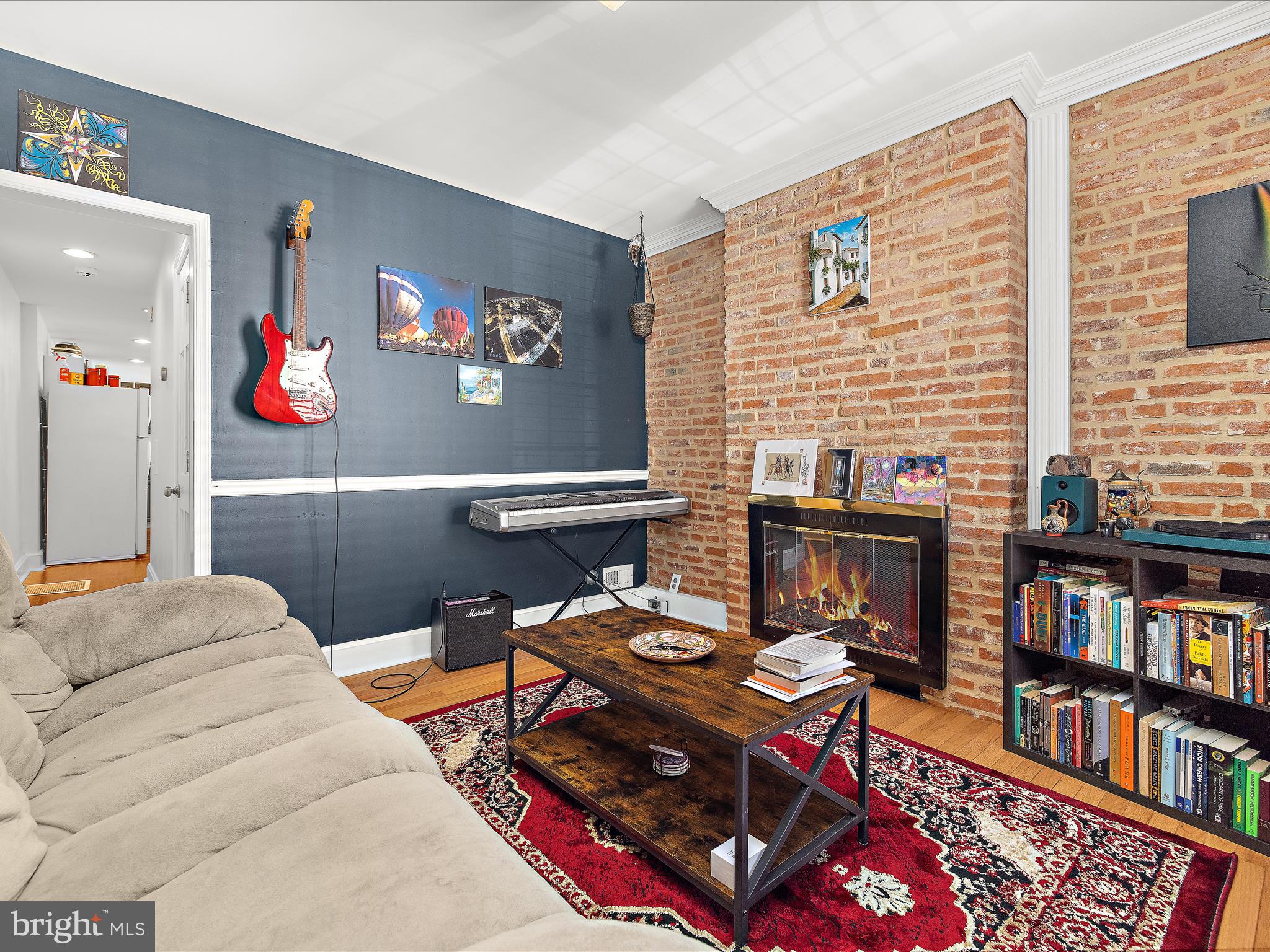 1313 Patapsco Street Baltimore, MD 21230 - Photo 5 of 30 a living room with furniture a bookshelf and a window