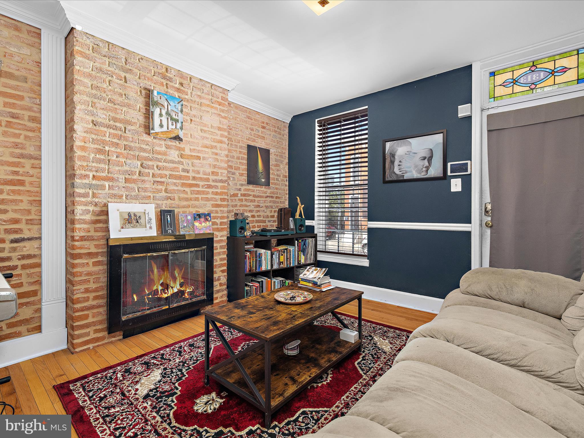 1313 Patapsco Street Baltimore, MD 21230 - Photo 6 of 30 a living room with furniture a flat screen tv and a fireplace