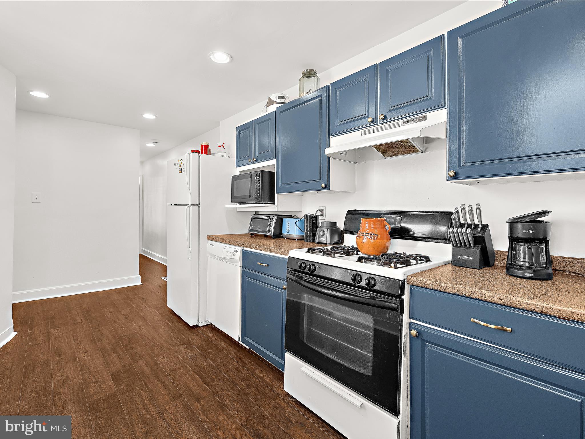 1313 Patapsco Street Baltimore, MD 21230 - Photo 9 of 30 a kitchen with stainless steel appliances granite countertop a stove a sink dishwasher and a refrigerator with wooden floors