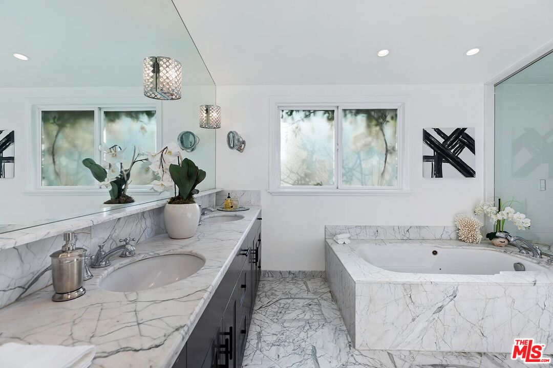 18106 Wakecrest Drive Malibu, CA 90265 - Photo 14 of 29 a bathroom with a tub sink and mirror