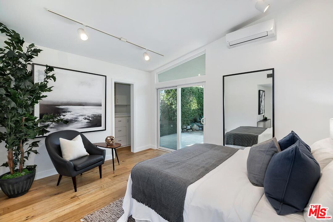 18106 Wakecrest Drive Malibu, CA 90265 - Photo 17 of 29 a bedroom with a bed and a chair