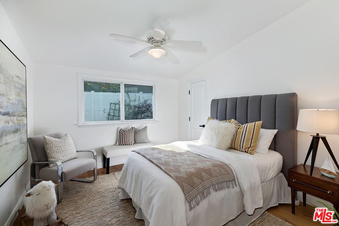 18106 Wakecrest Drive Malibu, CA 90265 - Photo 18 of 29 a bedroom with a bed and a window