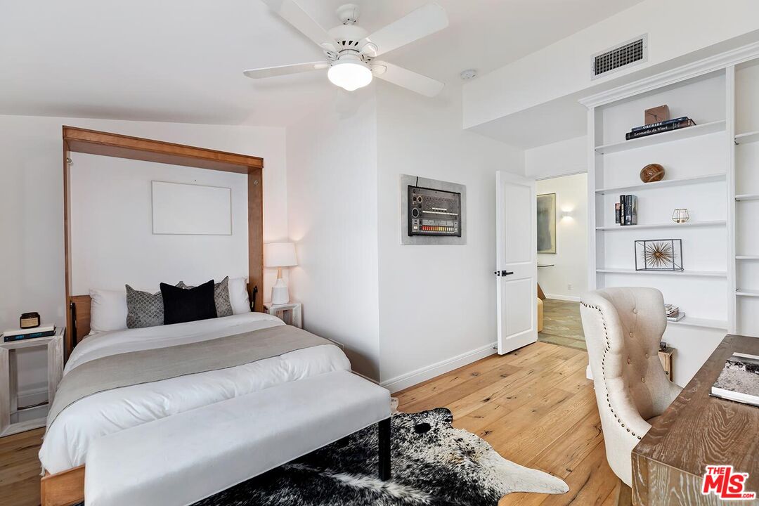 18106 Wakecrest Drive Malibu, CA 90265 - Photo 20 of 29 a bedroom with a bed and wooden floor