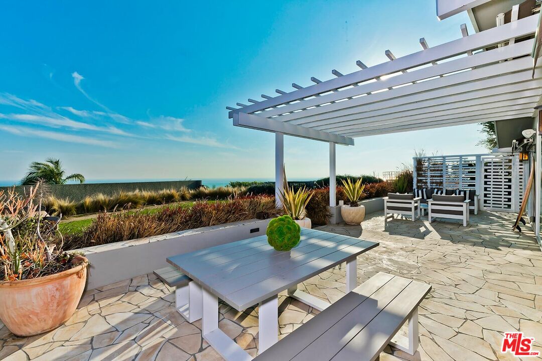 18106 Wakecrest Drive Malibu, CA 90265 - Photo 22 of 29 a view of a patio with chairs and potted plants