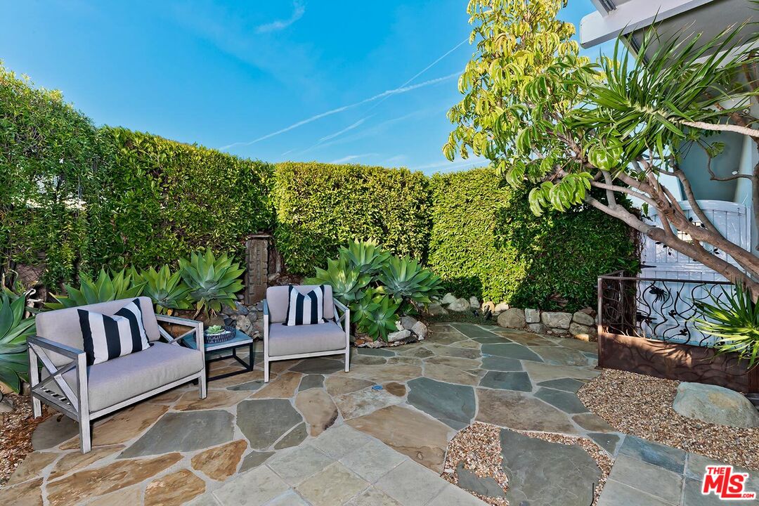 18106 Wakecrest Drive Malibu, CA 90265 - Photo 3 of 29 a view of a patio with a table and chairs and potted plants