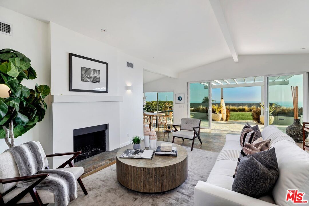 18106 Wakecrest Drive Malibu, CA 90265 - Photo 7 of 29 a living room with furniture a fireplace and a potted plant