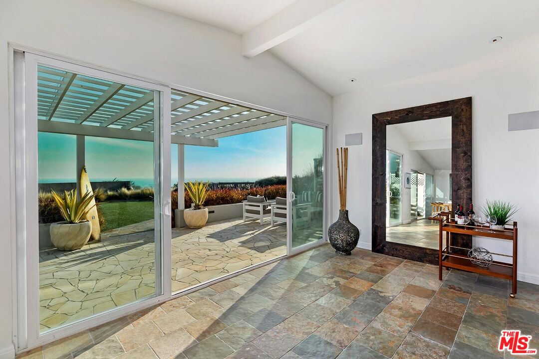 18106 Wakecrest Drive Malibu, CA 90265 - Photo 9 of 29 a living room with furniture and large glass door