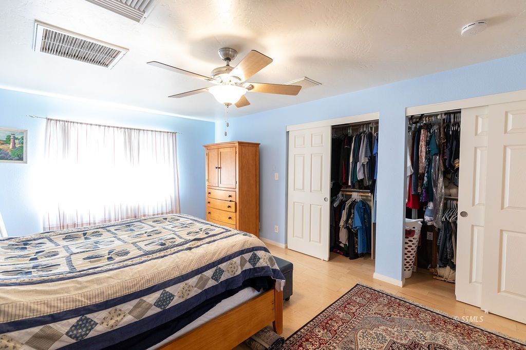 737 Scott Circle Ridgecrest, CA 93555 - Photo 24 of 49 a bedroom with a bed and a chandelier