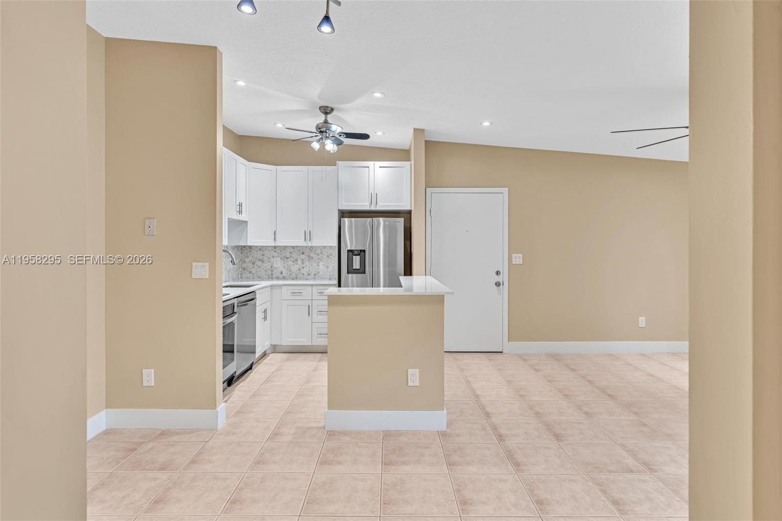 9487 West McNab Road, Unit 205 Tamarac, FL 33321 - Photo 11 of 44 a view of a kitchen with a sink and a refrigerator