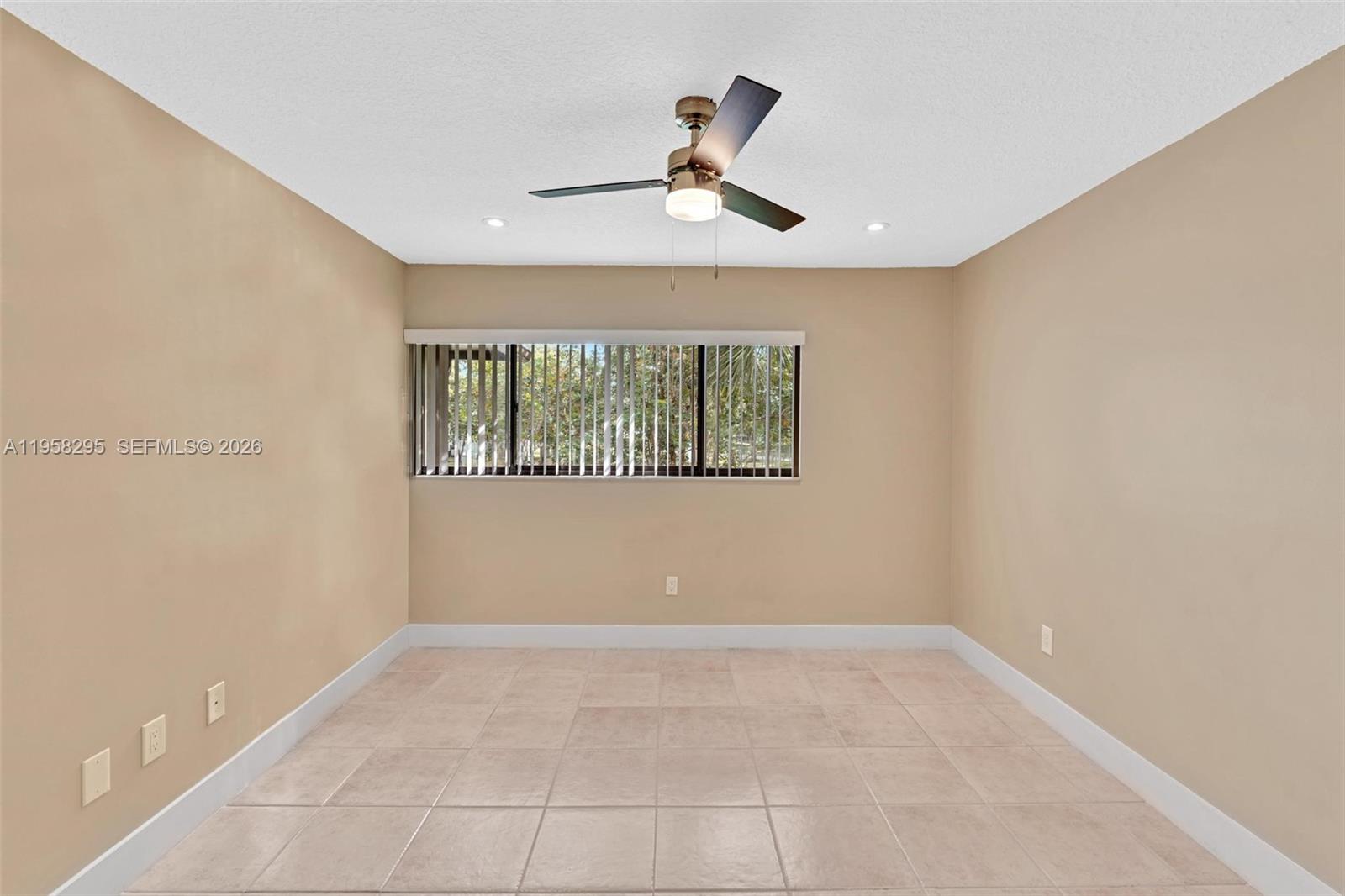 9487 West McNab Road, Unit 205 Tamarac, FL 33321 - Photo 15 of 44 a view of an empty room with a window