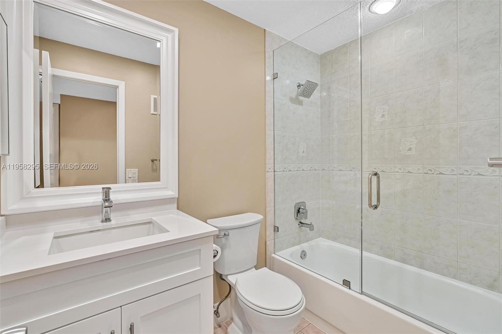 9487 West McNab Road, Unit 205 Tamarac, FL 33321 - Photo 18 of 44 a bathroom with a sink a toilet and shower