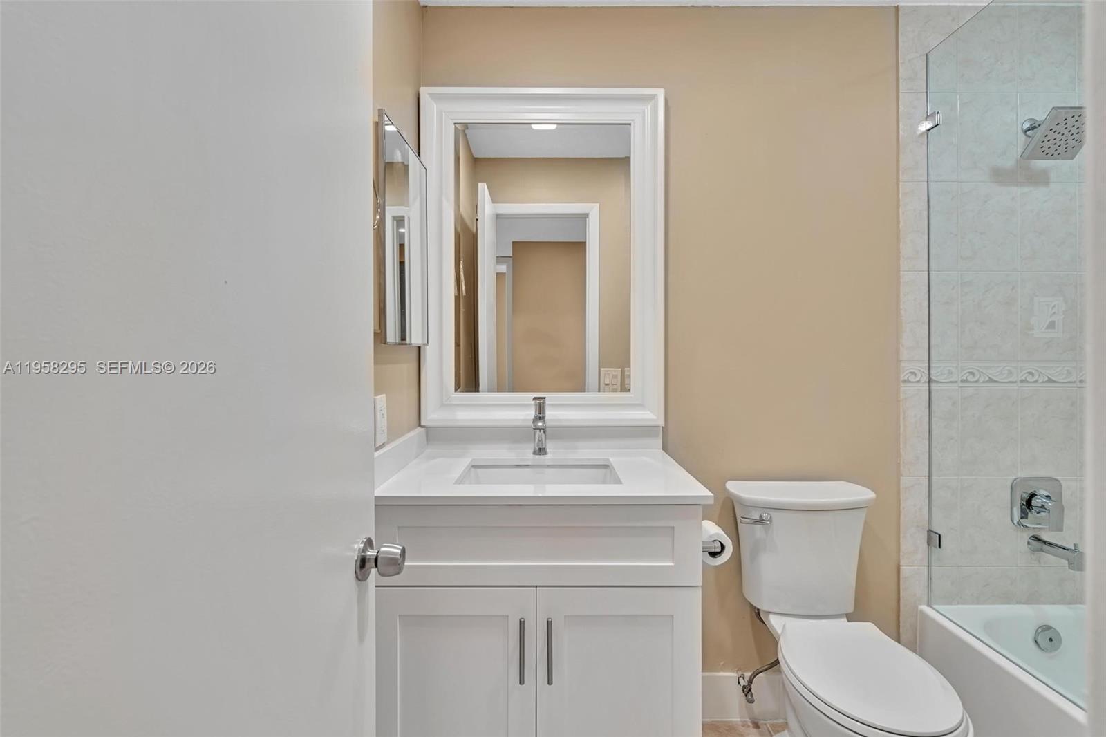 9487 West McNab Road, Unit 205 Tamarac, FL 33321 - Photo 19 of 44 a bathroom with a sink toilet vanity and shower