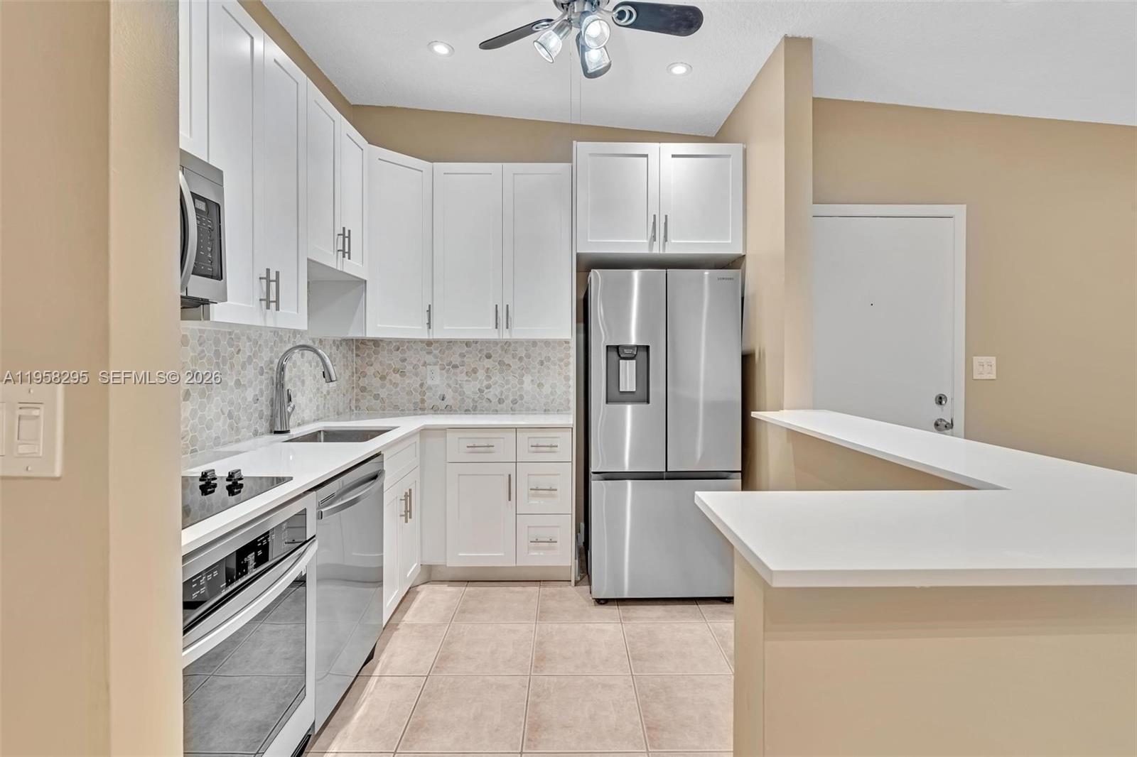 9487 West McNab Road, Unit 205 Tamarac, FL 33321 - Photo 2 of 44 a kitchen with a sink a stove and refrigerator