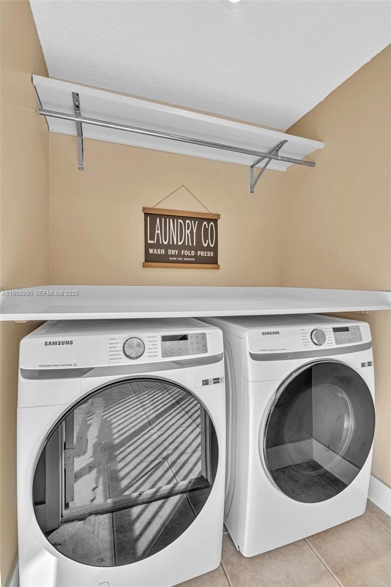 9487 West McNab Road, Unit 205 Tamarac, FL 33321 - Photo 23 of 44 a utility room with dryer and washer