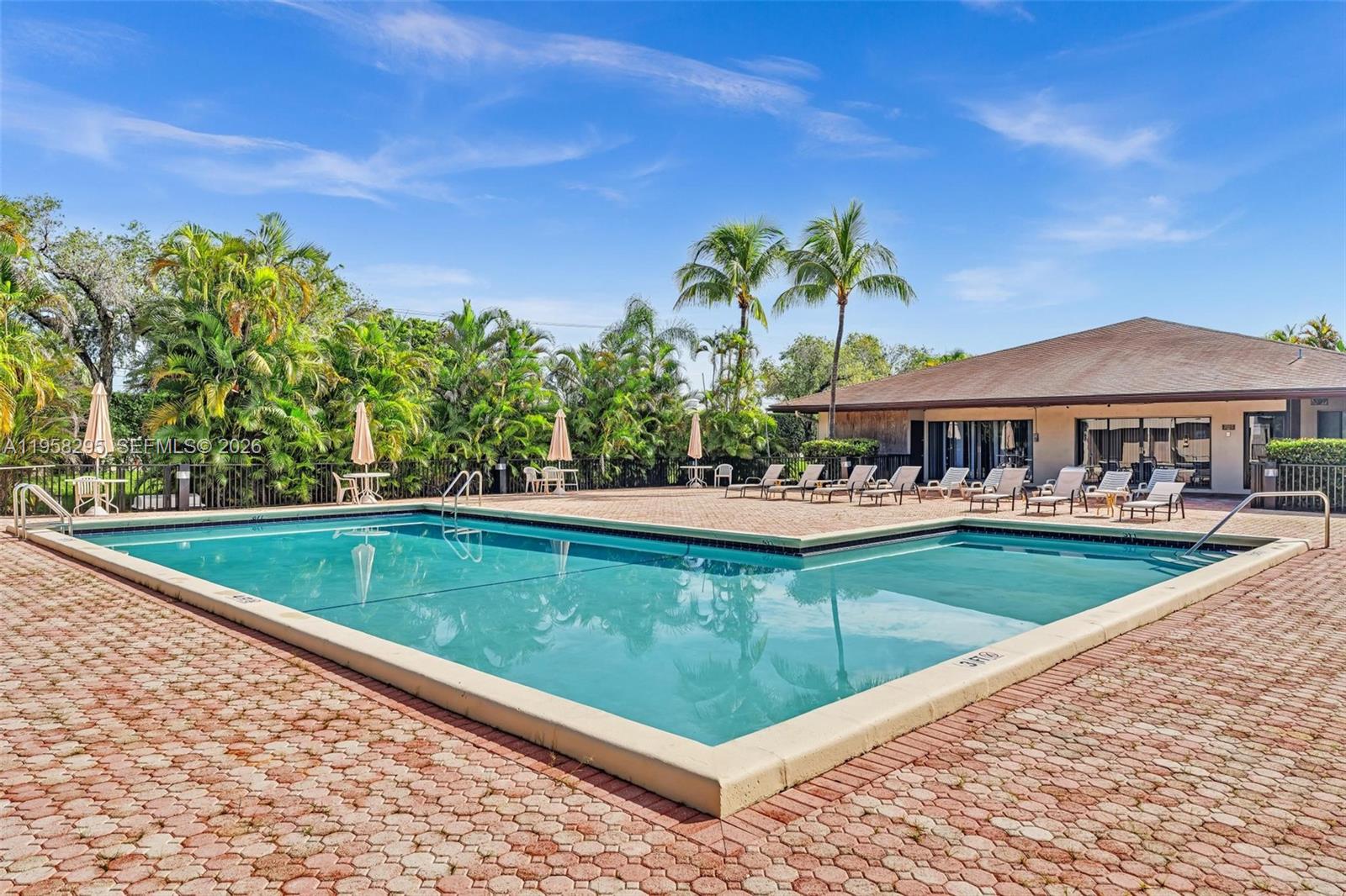 9487 West McNab Road, Unit 205 Tamarac, FL 33321 - Photo 34 of 44 a view of a swimming pool with a patio