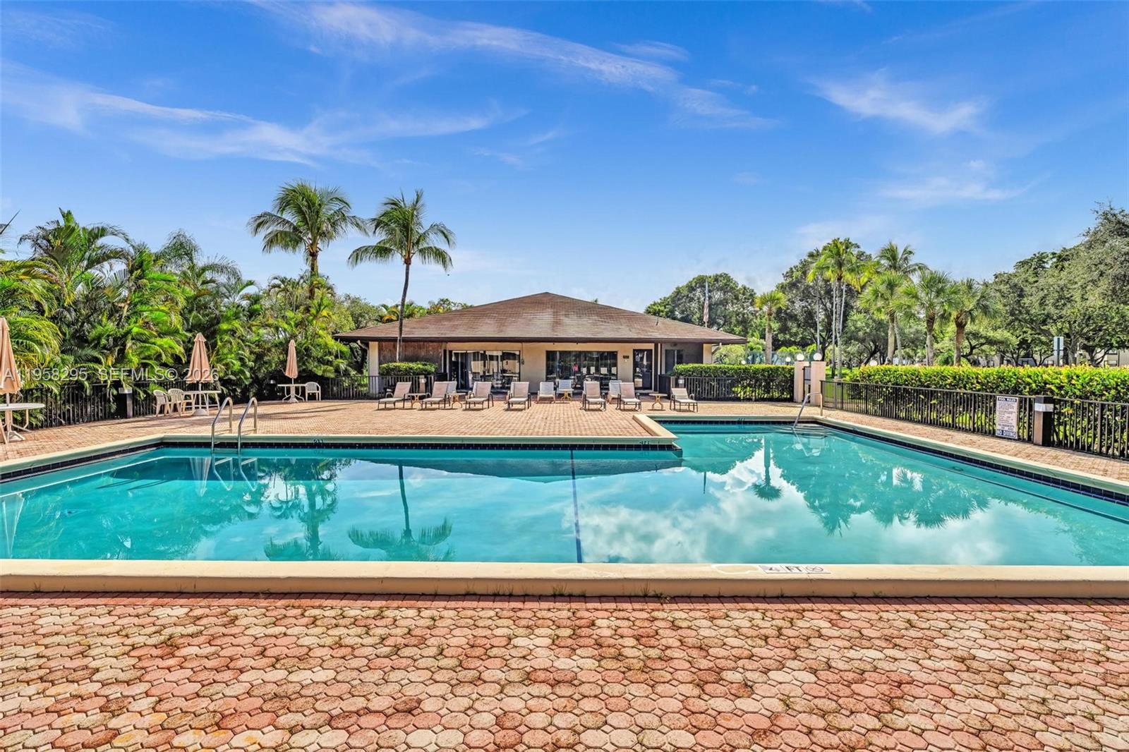 9487 West McNab Road, Unit 205 Tamarac, FL 33321 - Photo 35 of 44 a view of a house with a swimming pool