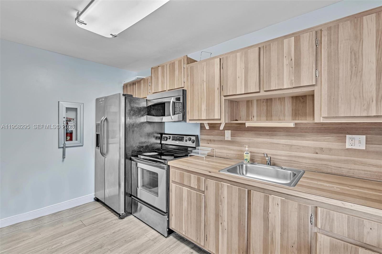 9487 West McNab Road, Unit 205 Tamarac, FL 33321 - Photo 42 of 44 a kitchen with stainless steel appliances granite countertop a stove a sink dishwasher and a refrigerator