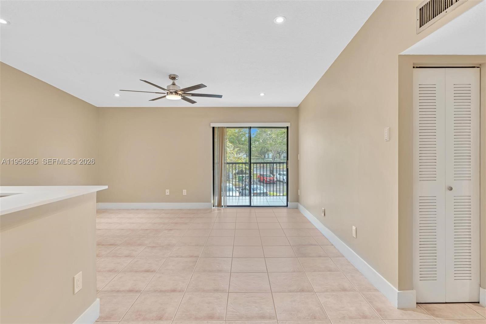 9487 West McNab Road, Unit 205 Tamarac, FL 33321 - Photo 5 of 44 a view of an empty room with a window