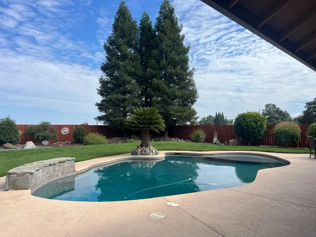 a view of swimming pool with a yard