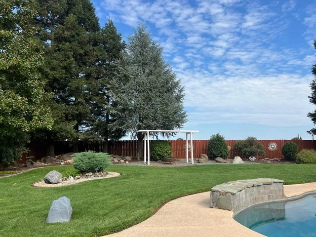 a view of a garden with furniture