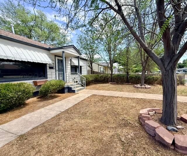 4623 Crockett Street Amarillo, TX 79110 - Photo 2 of 9 a front view of a house with a yard and potted plants