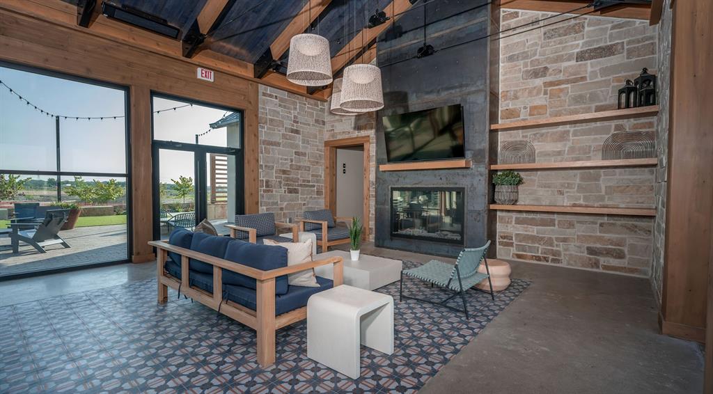 907 River Sky Road Lavon, TX 75166 - Photo 18 of 21 a living room with furniture a flat screen tv and a fireplace