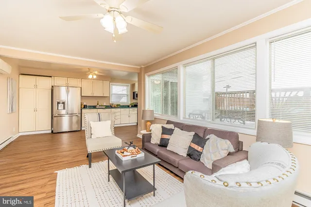 a living room with fireplace furniture and a large window